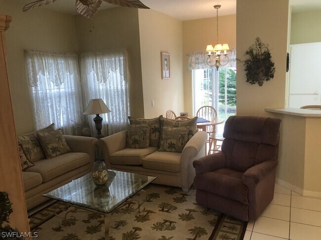 tiled living room featuring ceiling fan with notable chandelier