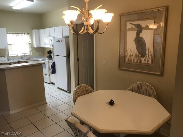 tiled dining area featuring a notable chandelier