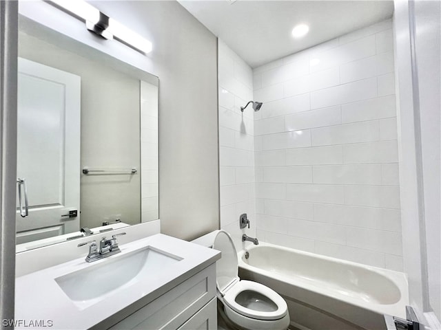 full bathroom with toilet, vanity, and tiled shower / bath