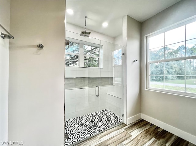 bathroom with a shower with door