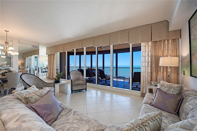 tiled living room with a water view and a notable chandelier