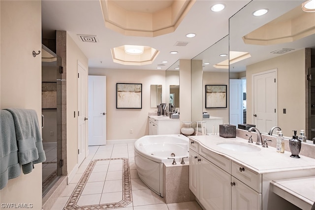 bathroom featuring tile floors, a tray ceiling, dual bowl vanity, and separate shower and tub