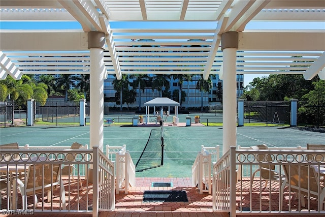 exterior space with a pergola and tennis court