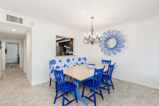 tiled dining space featuring a chandelier and ornamental molding