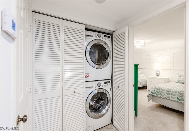 laundry room with light carpet and stacked washer and clothes dryer