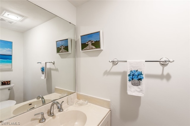 bathroom with toilet and vanity