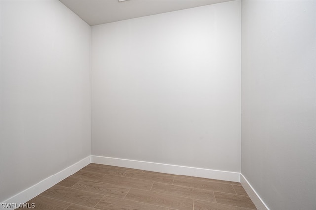 empty room with light hardwood / wood-style flooring