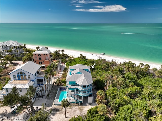 birds eye view of property with a water view and a view of the beach