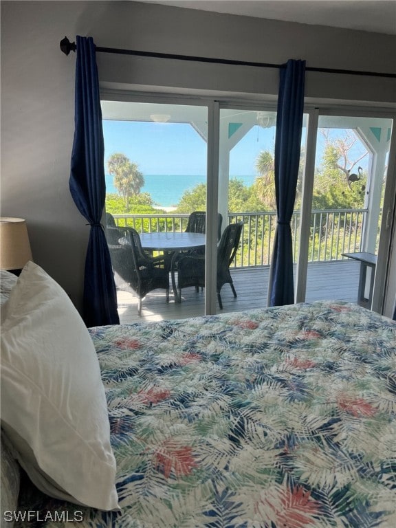 bedroom with a water view and access to outside