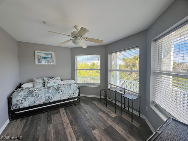 bedroom with ceiling fan and dark wood-type flooring