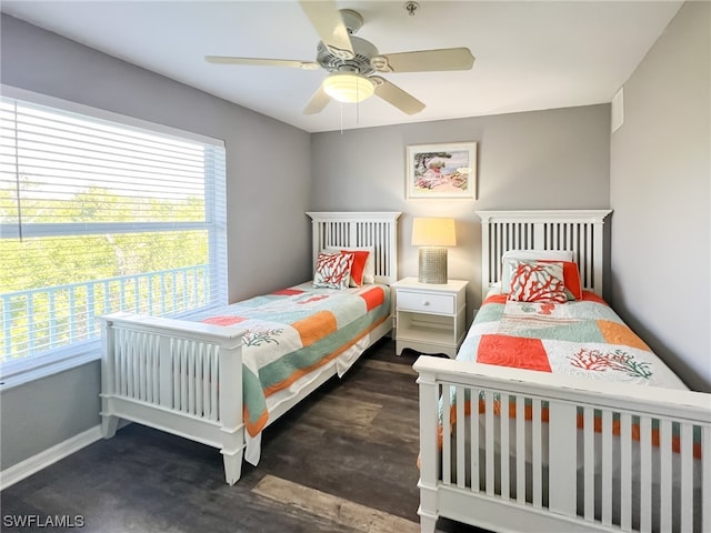 bedroom with dark hardwood / wood-style flooring and ceiling fan