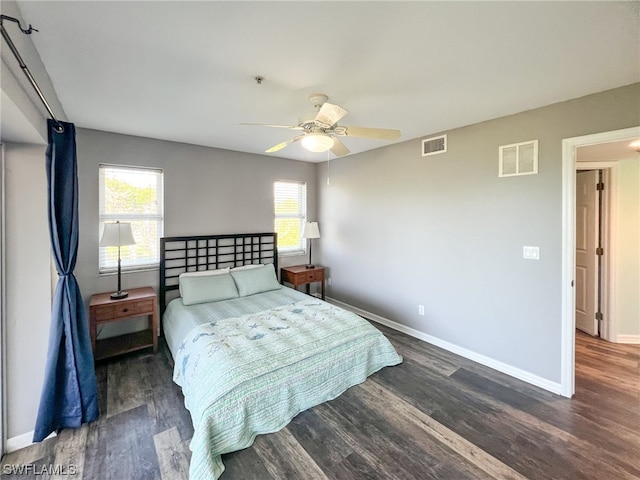 bedroom with dark hardwood / wood-style floors and ceiling fan