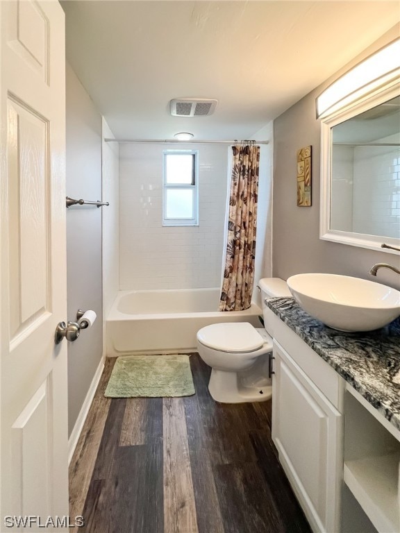 full bathroom featuring shower / bath combination with curtain, wood-type flooring, toilet, and vanity