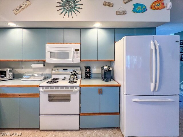 kitchen featuring blue cabinets and white appliances