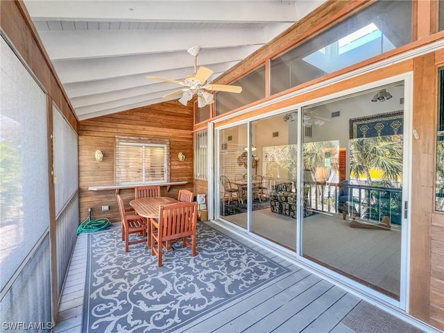 sunroom / solarium with vaulted ceiling with skylight and ceiling fan