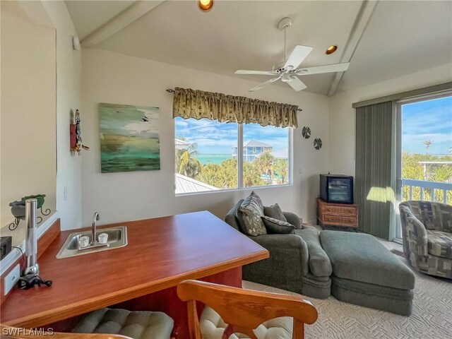 office featuring sink, ceiling fan, carpet flooring, and a healthy amount of sunlight