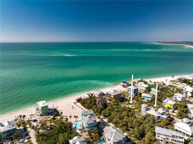 drone / aerial view featuring a water view and a view of the beach