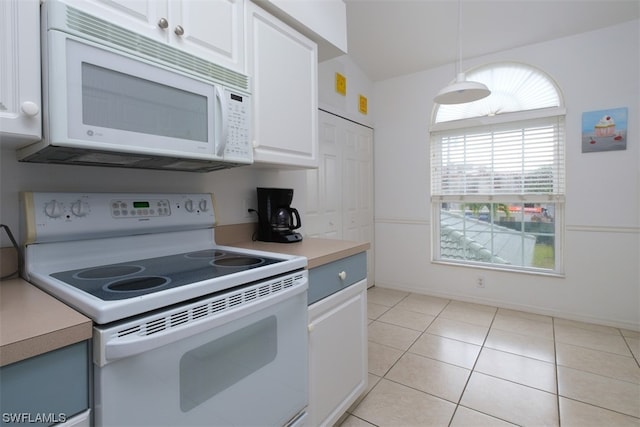 kitchen with white cabinets, pendant lighting, light tile flooring, and white appliances