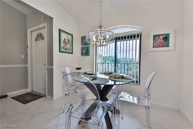 dining space featuring light tile patterned floors and an inviting chandelier