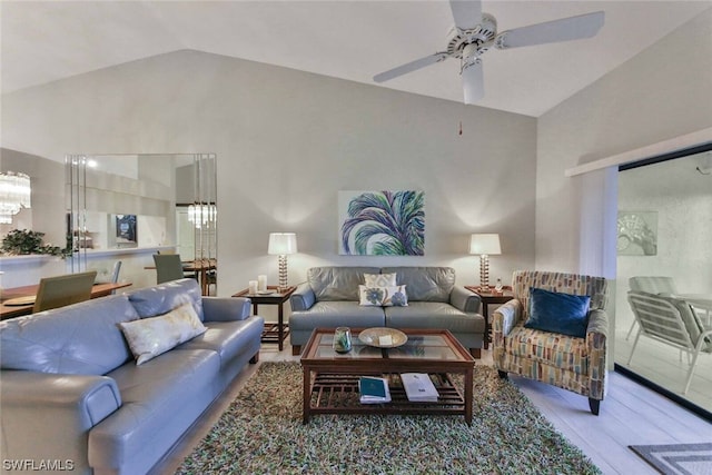 living room with ceiling fan, hardwood / wood-style floors, and lofted ceiling