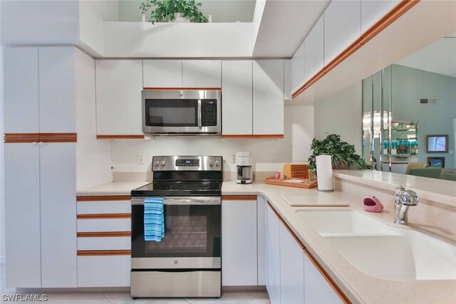 kitchen featuring white cabinets, sink, and stainless steel appliances