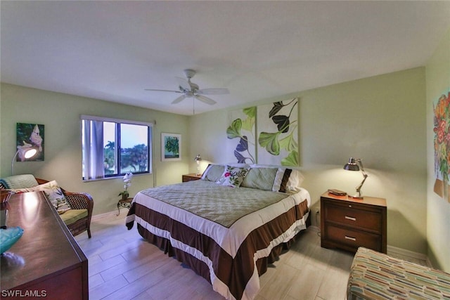 bedroom with ceiling fan and light hardwood / wood-style flooring