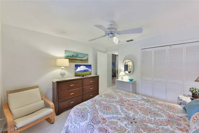 bedroom featuring a closet, ceiling fan, and light colored carpet