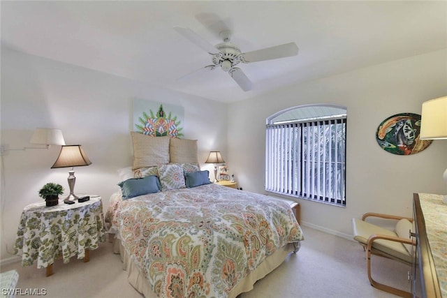 bedroom featuring light carpet and ceiling fan