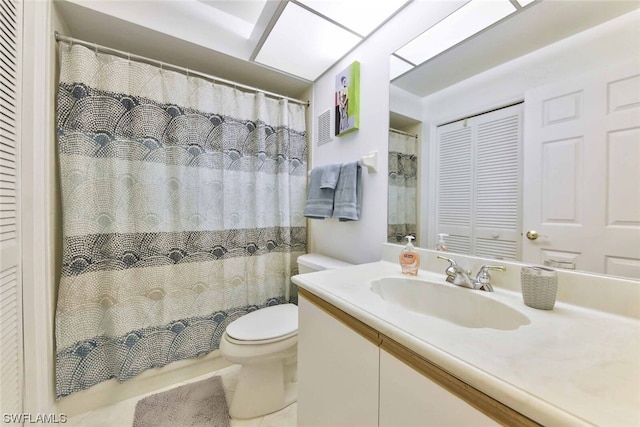 bathroom featuring toilet, vanity, and tile patterned floors