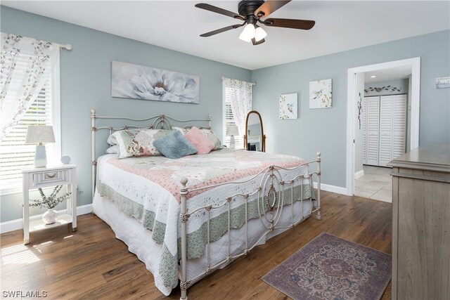 bedroom with ceiling fan, connected bathroom, and hardwood / wood-style flooring