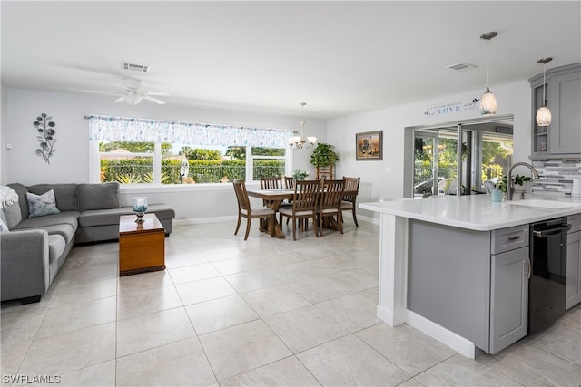 kitchen featuring black dishwasher, sink, ceiling fan with notable chandelier, and gray cabinets