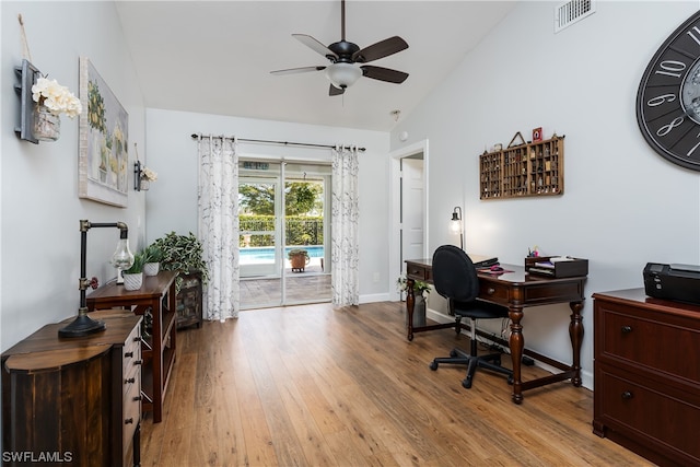 home office with ceiling fan, hardwood / wood-style flooring, and lofted ceiling