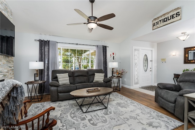 living room featuring ceiling fan, vaulted ceiling, and hardwood / wood-style floors