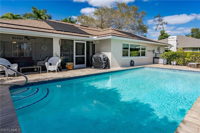 view of swimming pool with a patio area and ceiling fan