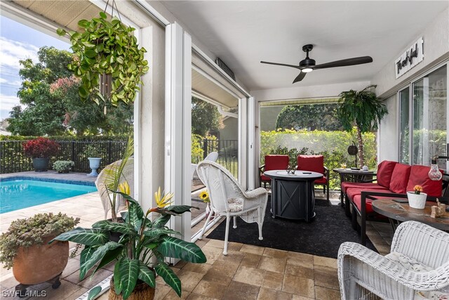 sunroom / solarium with plenty of natural light and ceiling fan