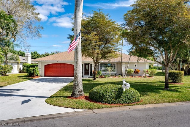 ranch-style house featuring a garage and a front lawn