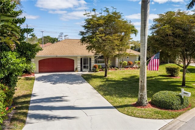 ranch-style house featuring a garage and a front yard