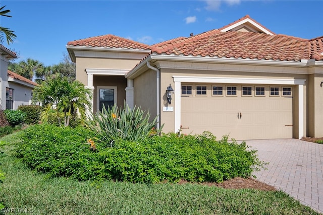 mediterranean / spanish-style home with a garage