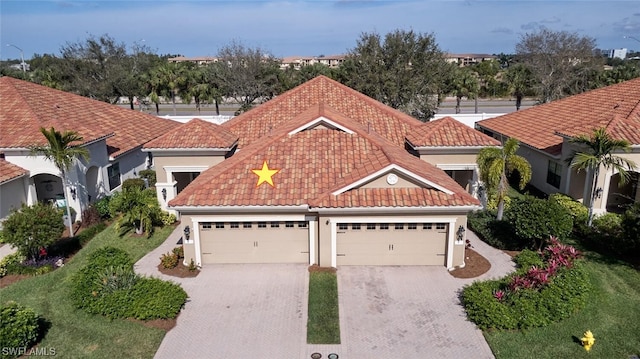 mediterranean / spanish-style home with a garage