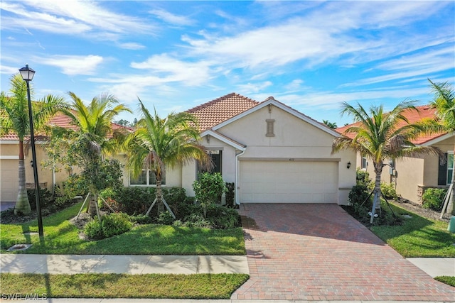 view of front of property with a front yard and a garage