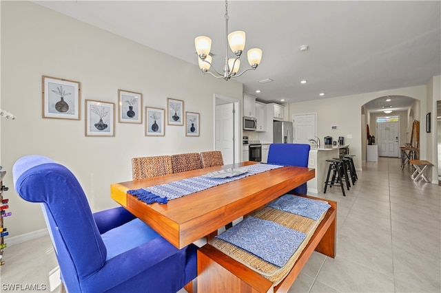 dining room with a notable chandelier and light tile flooring