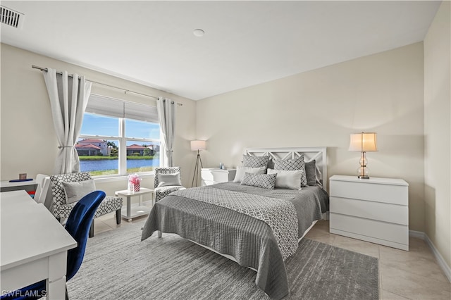 tiled bedroom with a water view