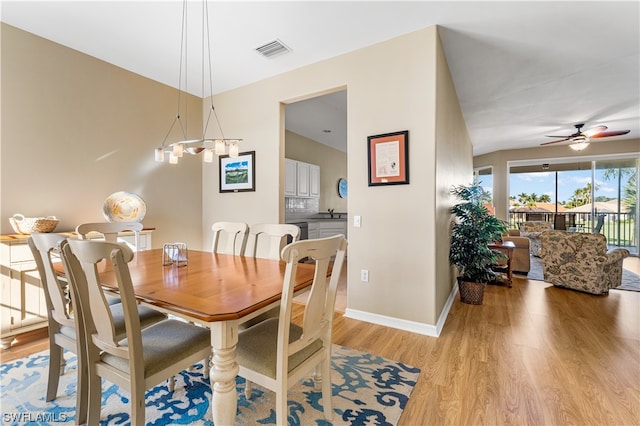 dining area with lofted ceiling, ceiling fan, and light hardwood / wood-style flooring