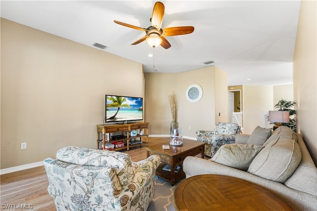 living room featuring light hardwood / wood-style floors and ceiling fan