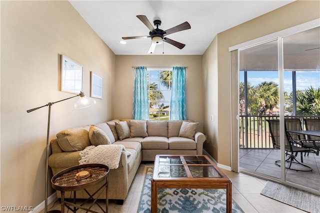 living room featuring light tile flooring, a healthy amount of sunlight, and ceiling fan