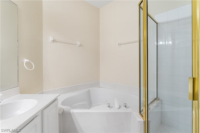 bathroom featuring shower with separate bathtub and vanity with extensive cabinet space