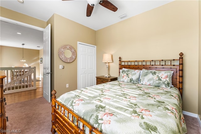 carpeted bedroom with a closet and ceiling fan