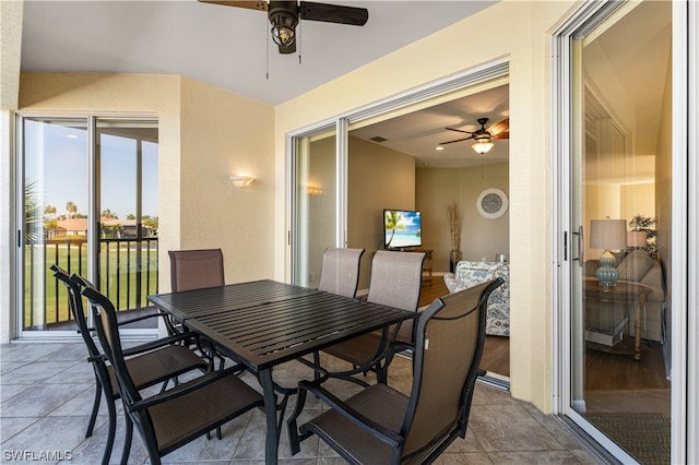 tiled dining room featuring ceiling fan