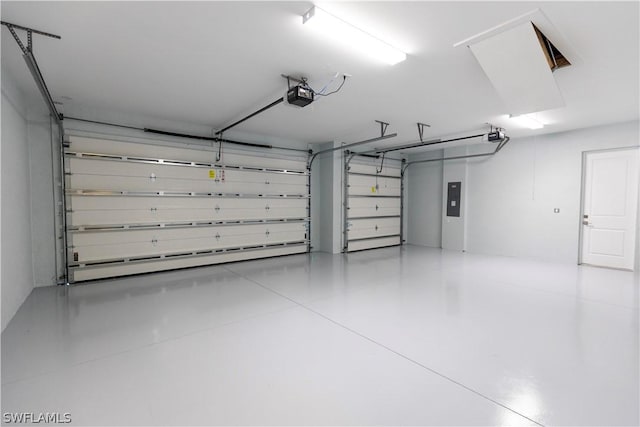 garage with electric panel and a garage door opener