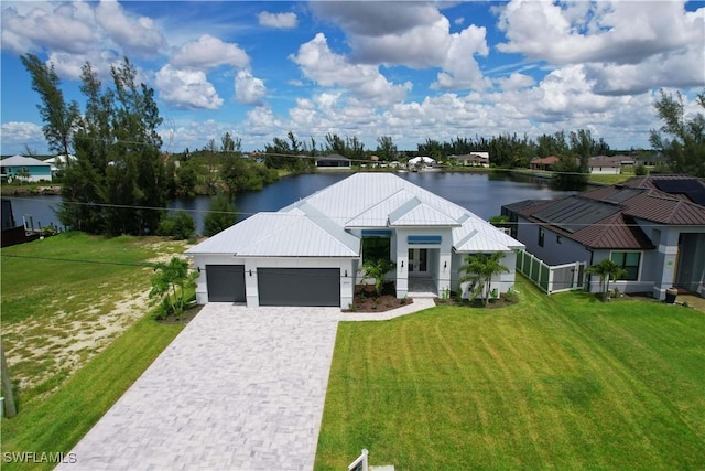 modern farmhouse with a front lawn, a water view, and a garage